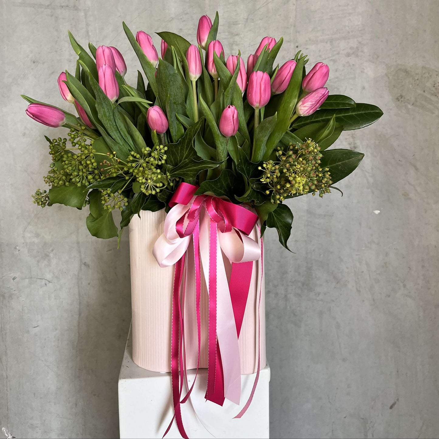 Mother's Day pink tulip flowers arrangement in blush vase by florist near me.