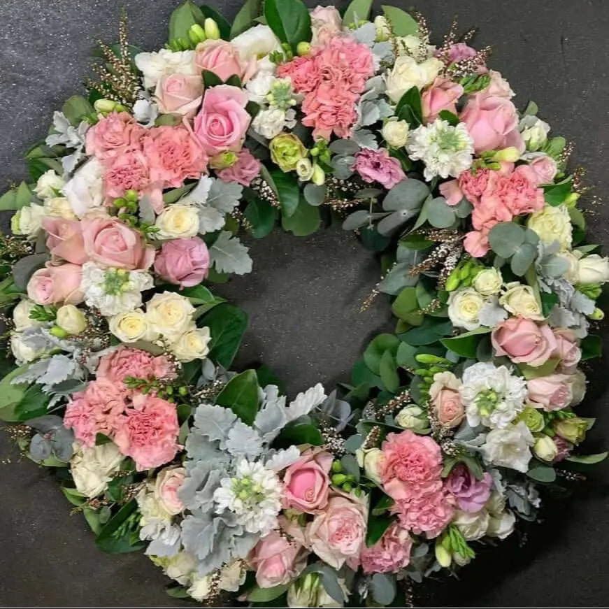 Wreath In Loving Bloom Pink, an elegant pink sympathy wreath for honor and remembrance with flowers and greenery.