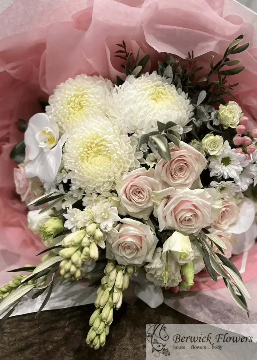 Bouquet of flowers with white, pink, and green colors on a pink background