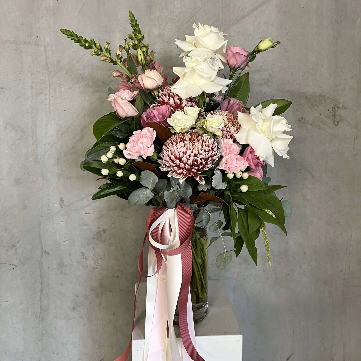 luxury vase arrangements featuring white avalanche roses, soft pink lisianthus, and dusty pink chrysanthemums.