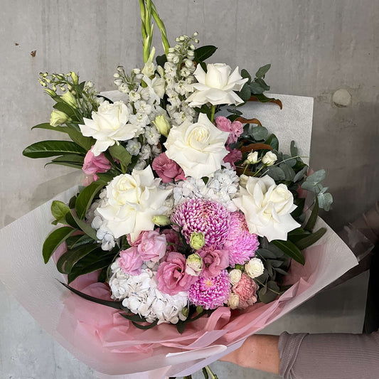 Pink Day Dream bouquet featuring white roses, blush pink lisianthus, and soft pink blooms, beautifully hand-tied.