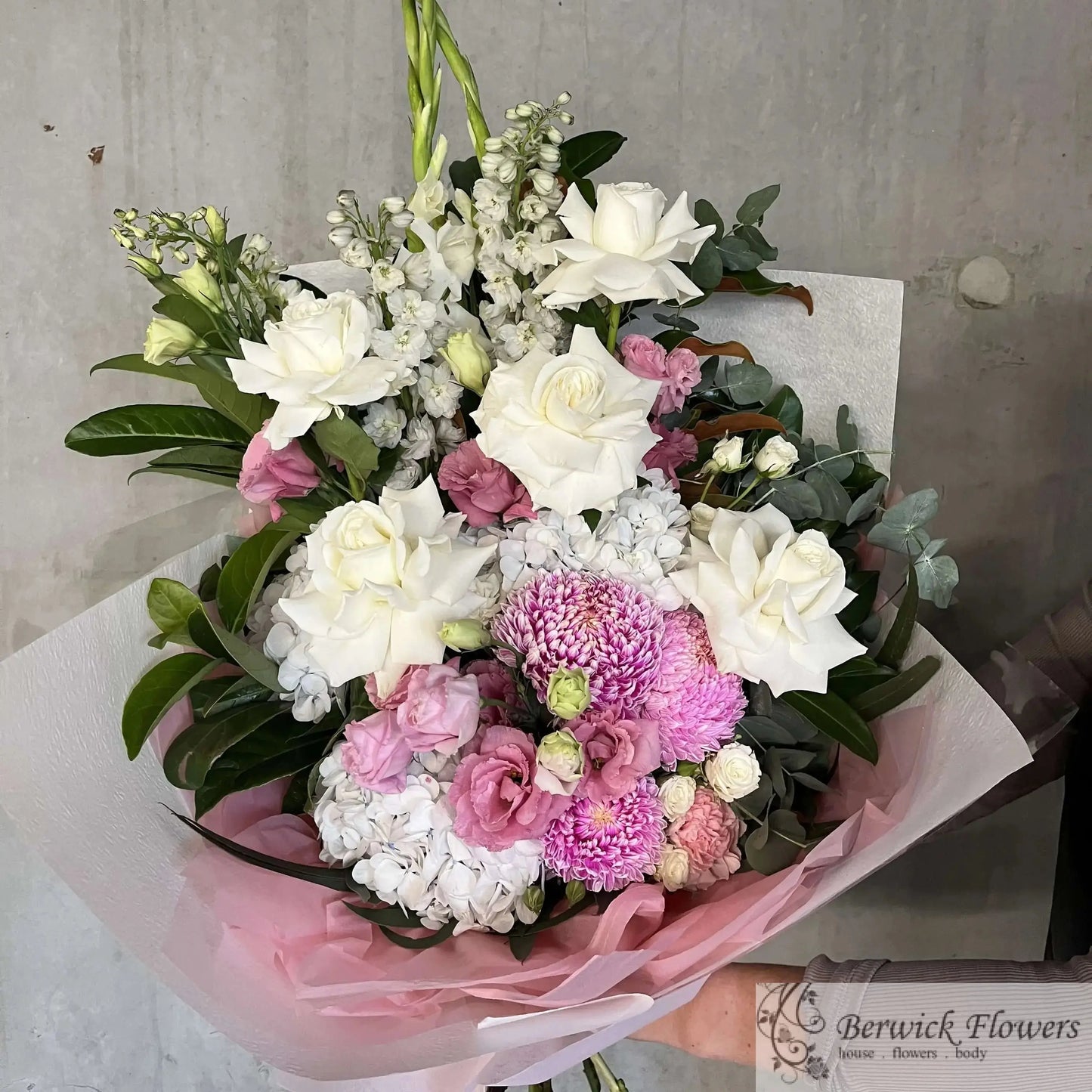 Bouquet of flowers with white, pink, and green colors on a gray background