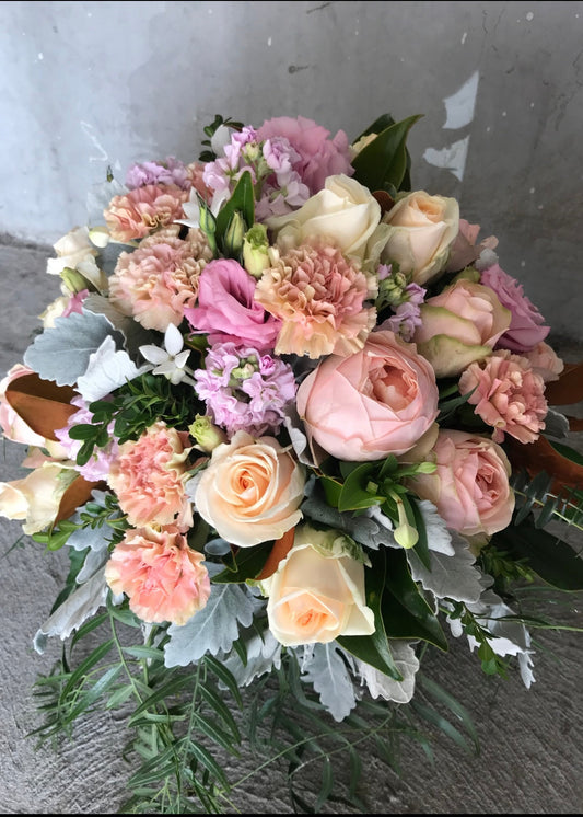 Bouquet of pink and white flowers on a gray surface