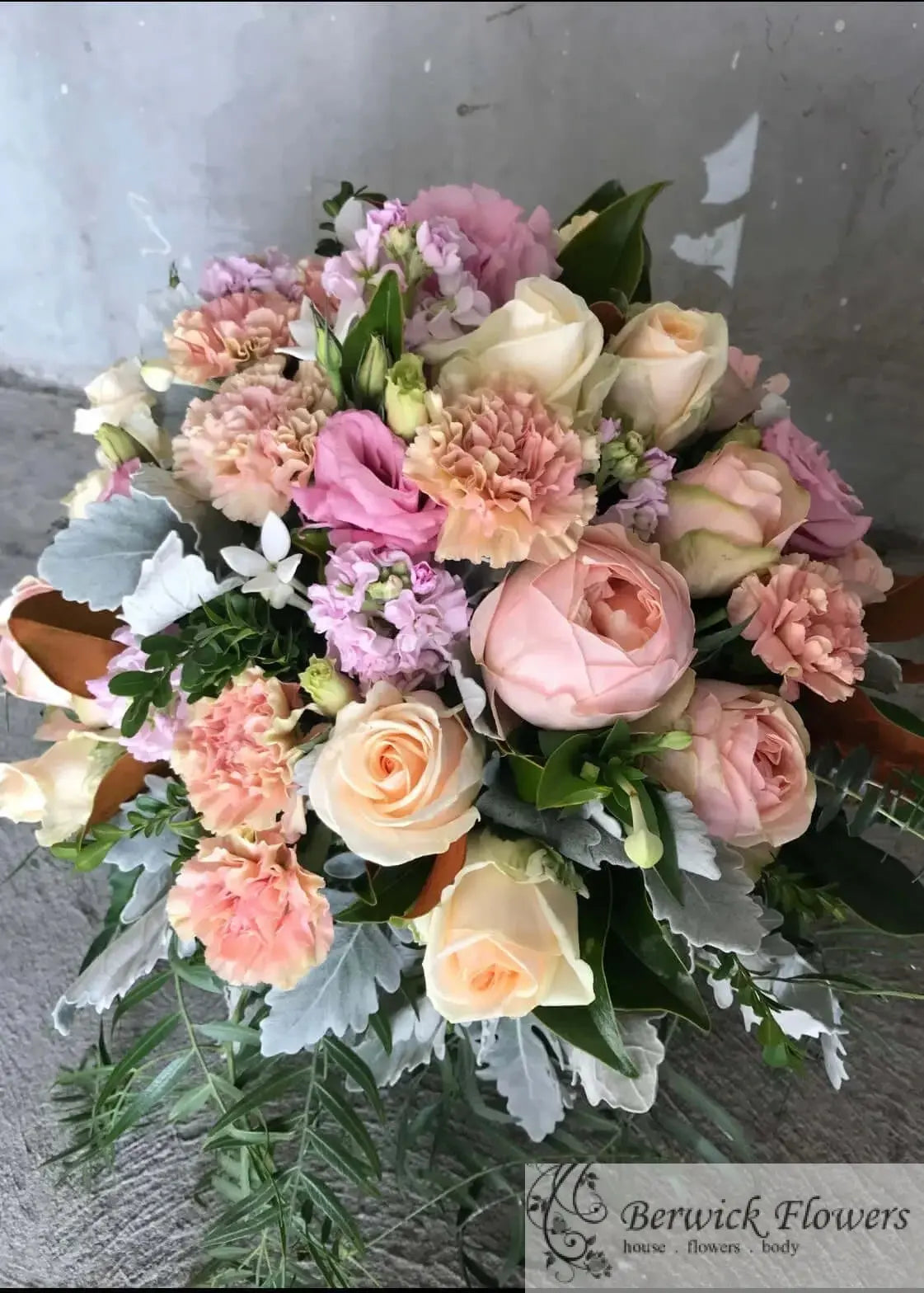 Bouquet of flowers with pink, white, and green colors on a gray background