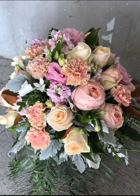 Bouquet of flowers with pink, white, and green colors on a gray background